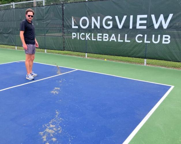 Longview Pickleball Club President Dustin Eberhart points out the damage.