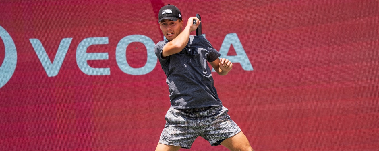 Connor Garnett returning a ball.