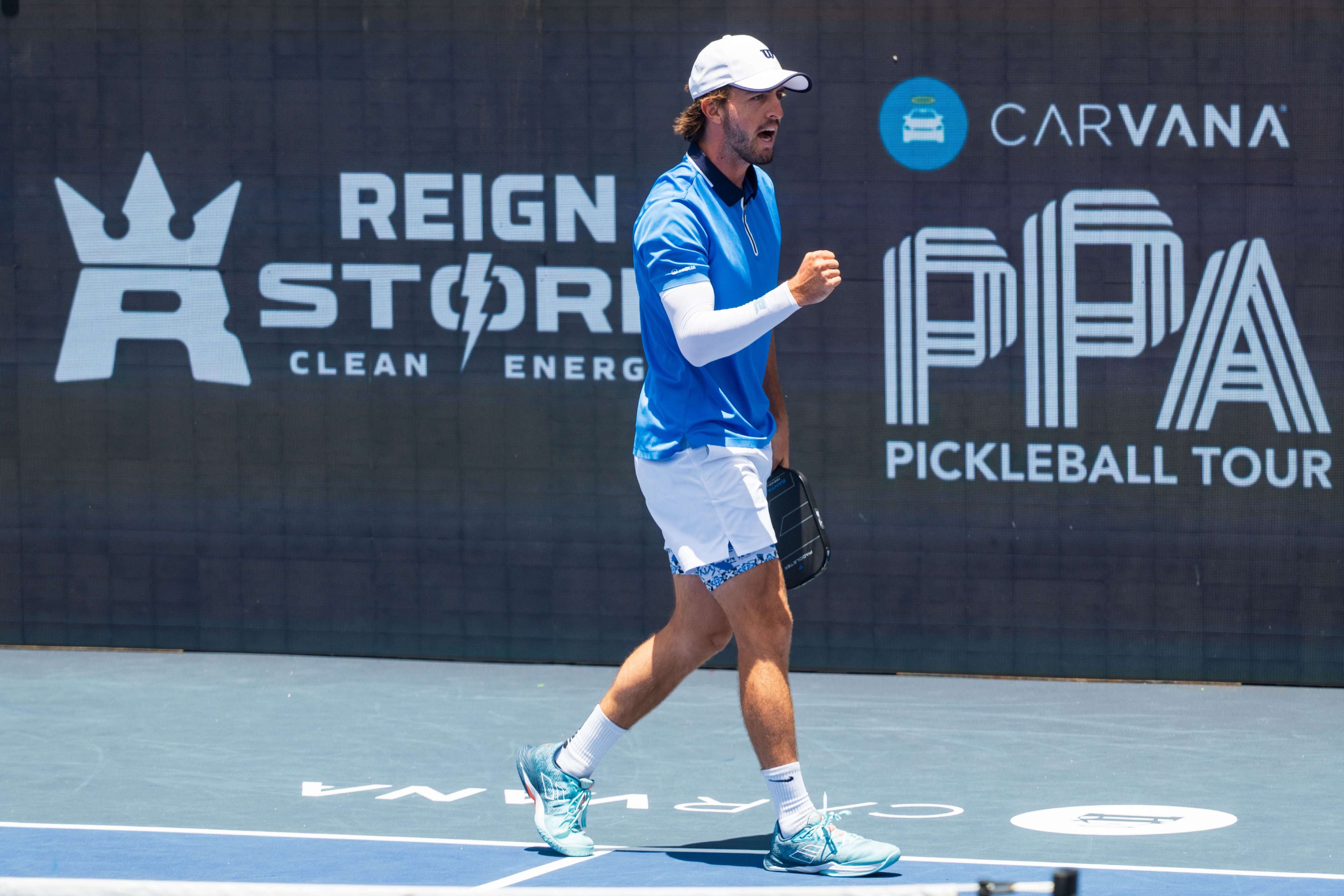 Hunter Johnson in a blue polo and white shorts