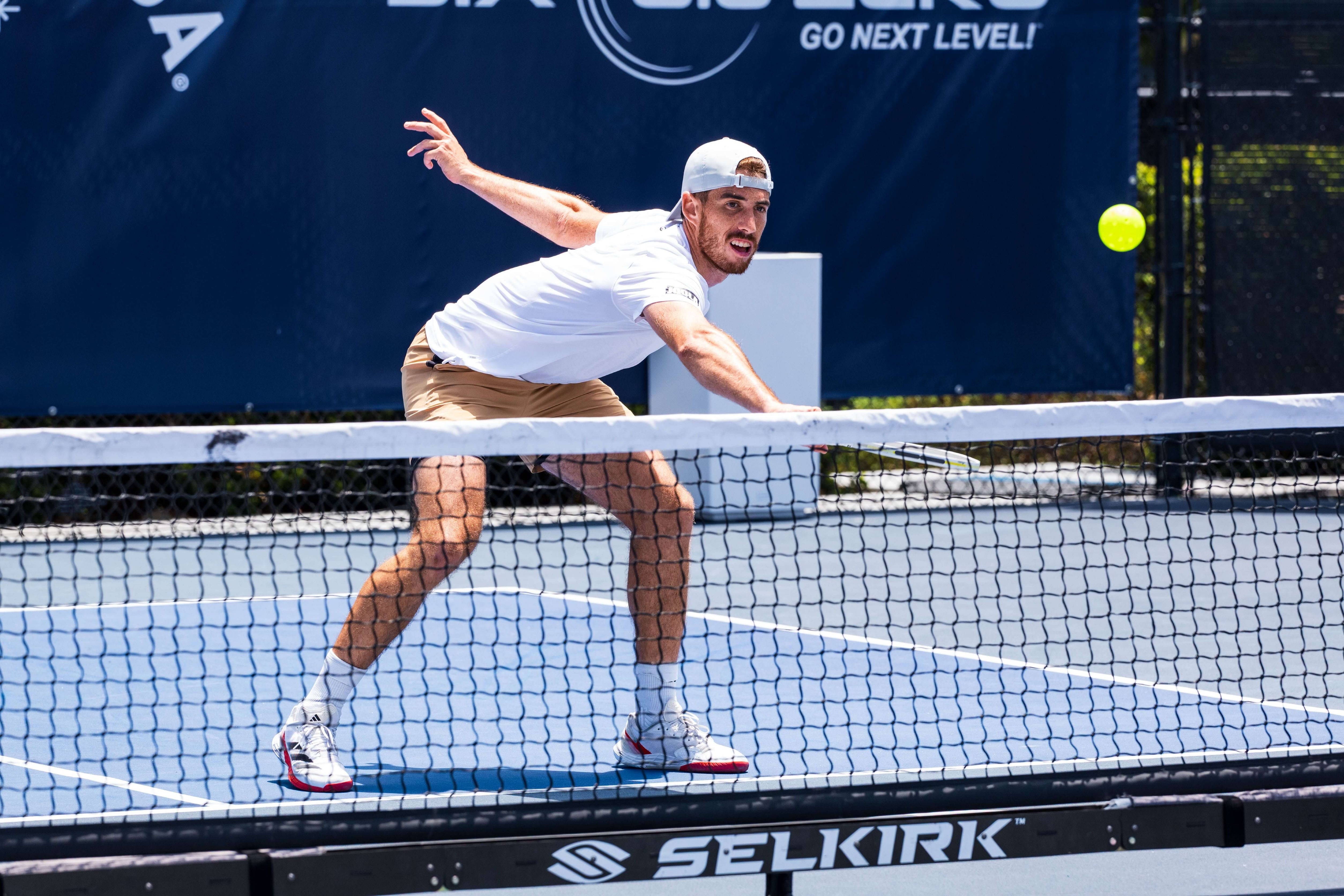Federico Staksrud in a white polo and khaki brown shorts