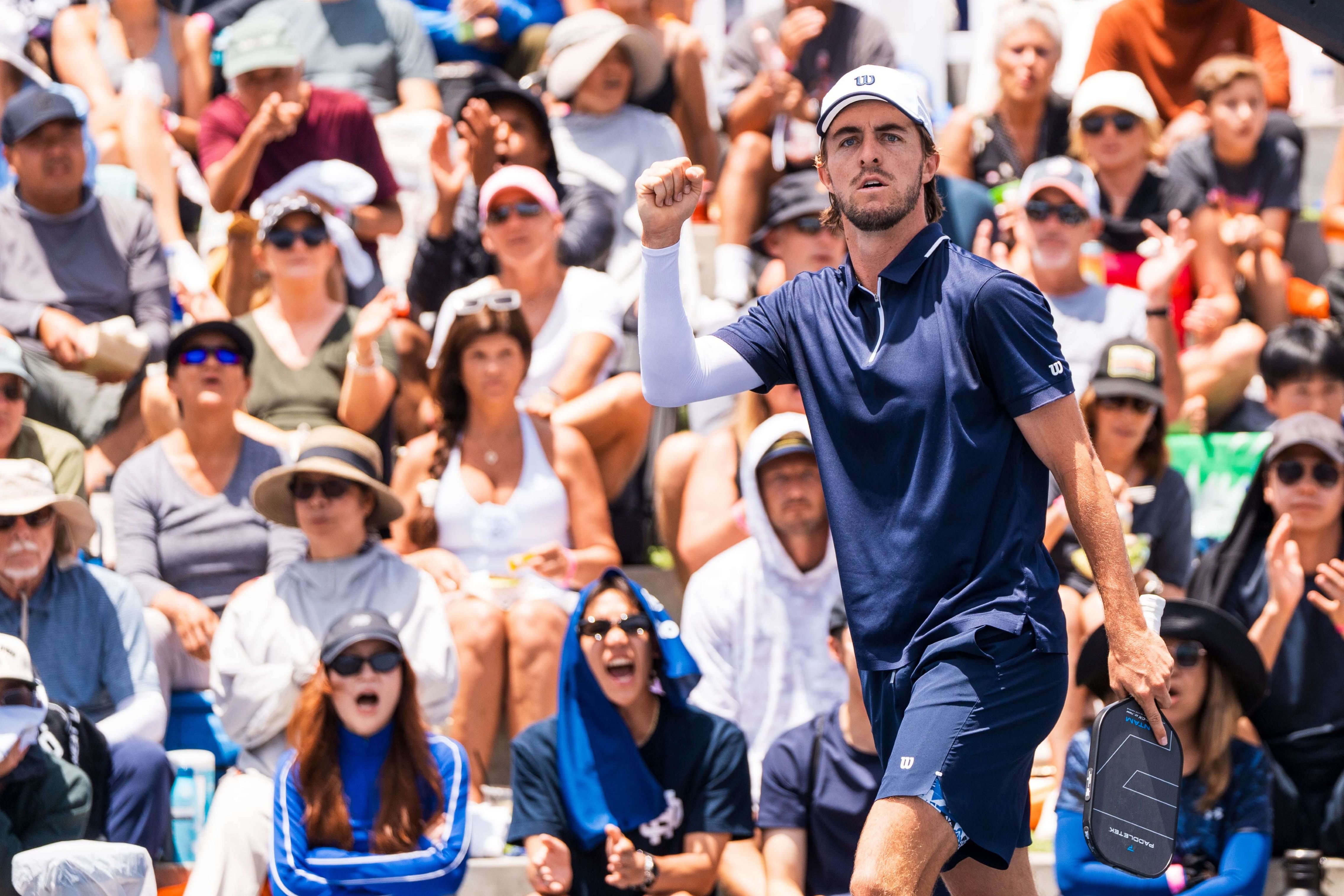 Johnson in a navy shirt and shorts with white arm sleeve and white hat