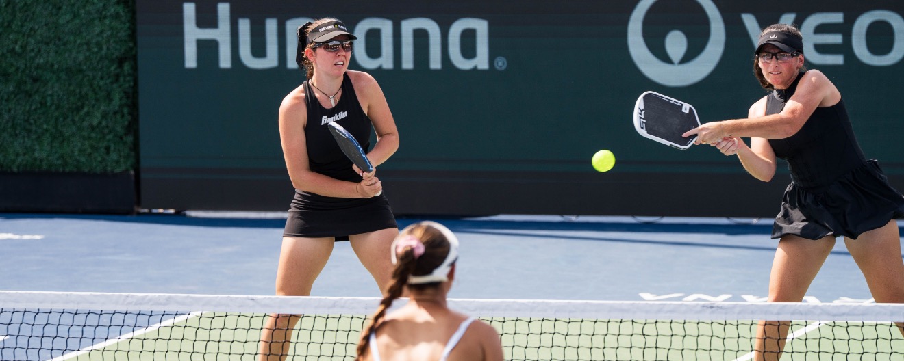 Rachel Rohrabacher takes a big backhand from the left side alongside Jorja Johnson