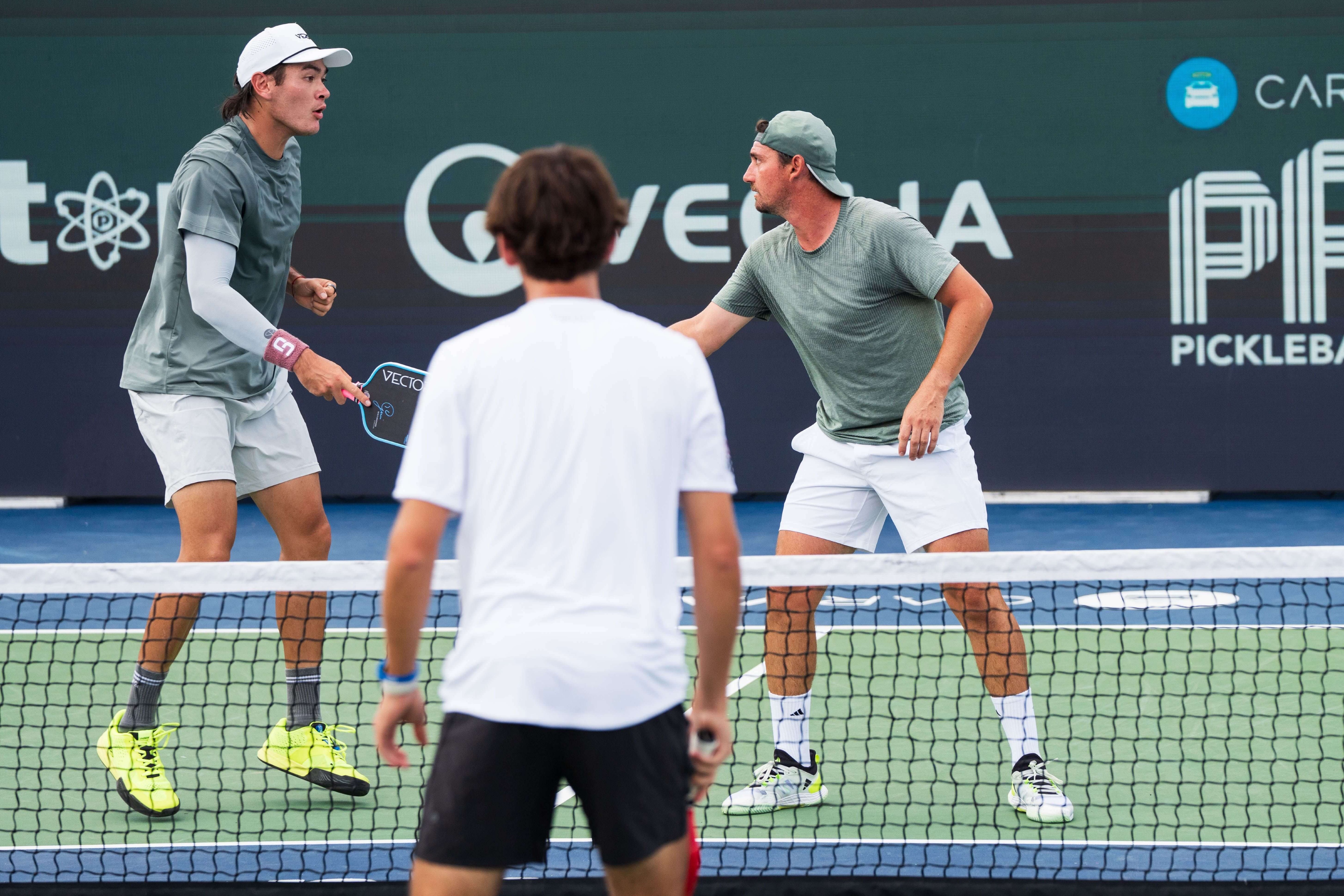 Hovenier and Arnold in sage green shirts and white shorts
