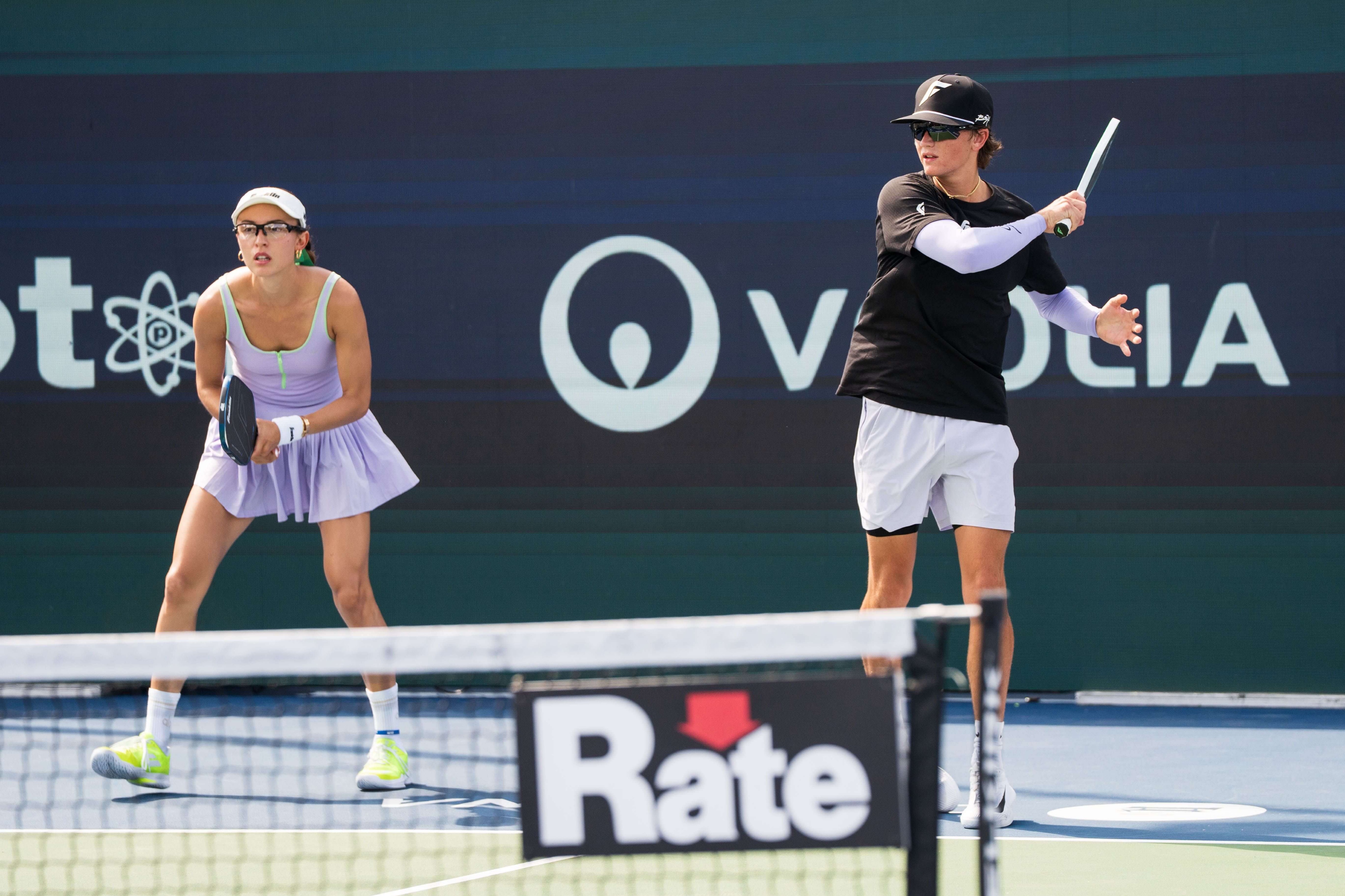 Parris in a light purple dress with neon yellow shoes 