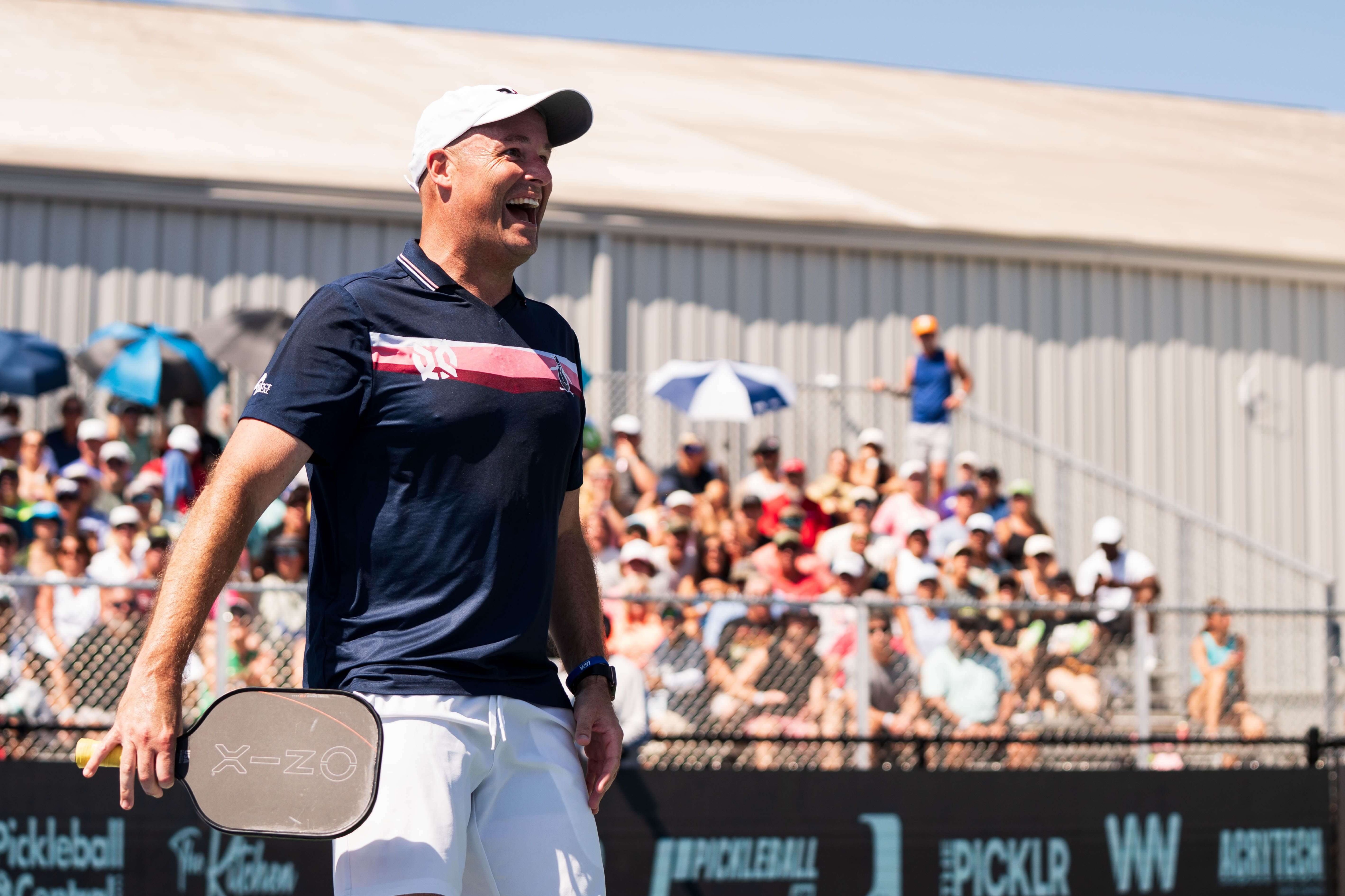 Wright in a navy blue shirt with pink color blocking, and white shorts