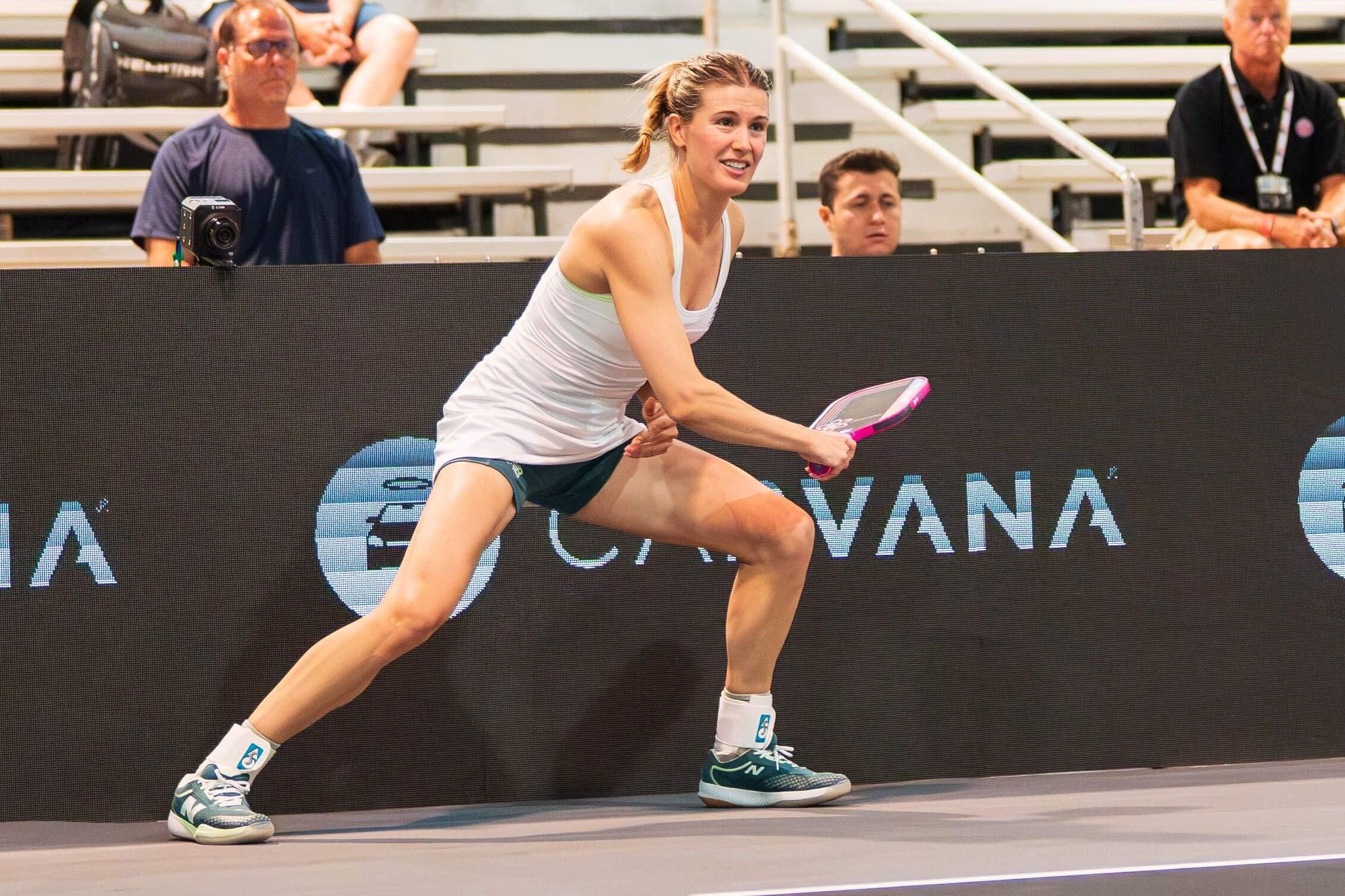 Bouchard in a white dress and teal blue shoes