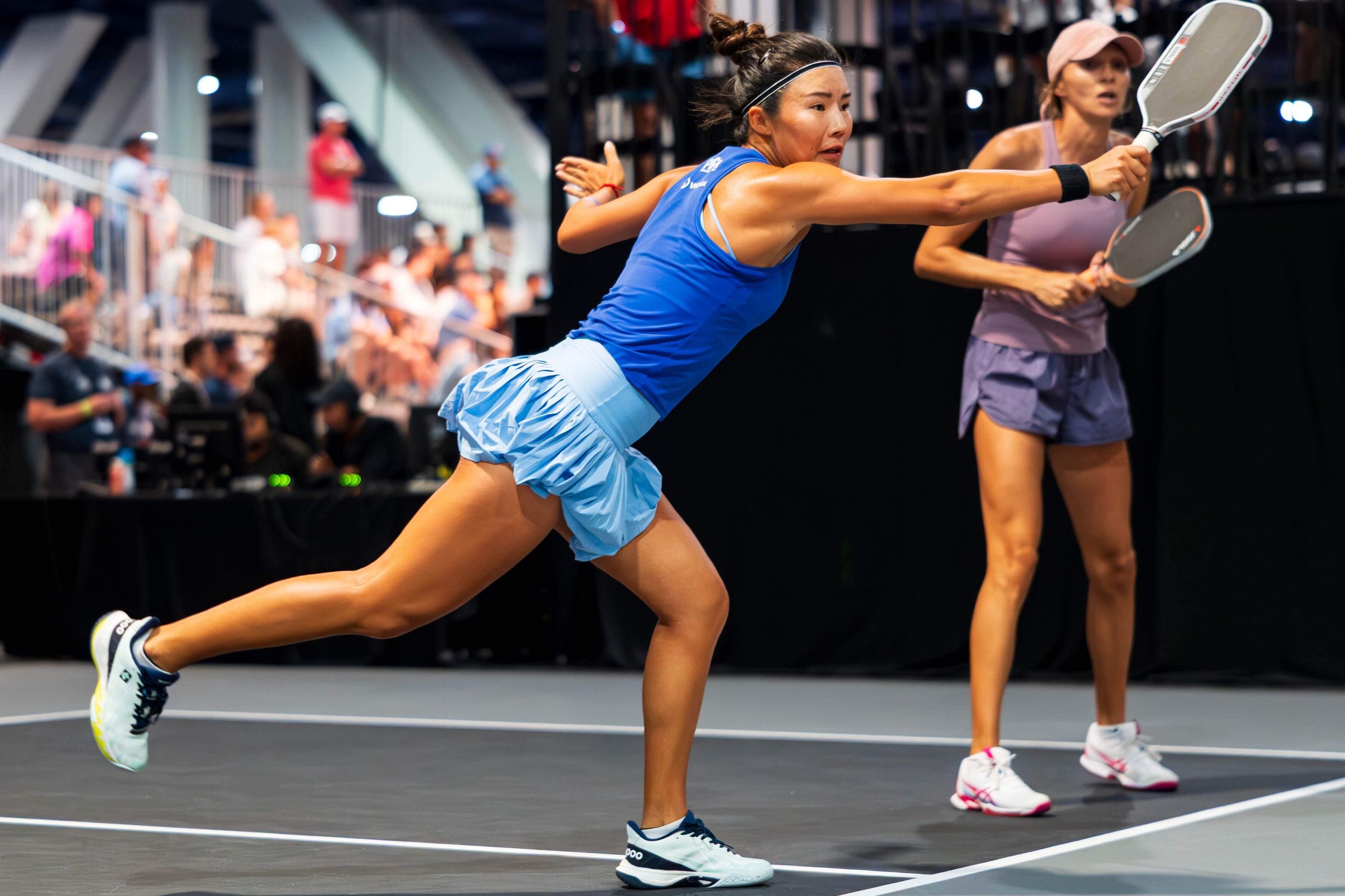 Kong in a dark blue tank, light blue skirt