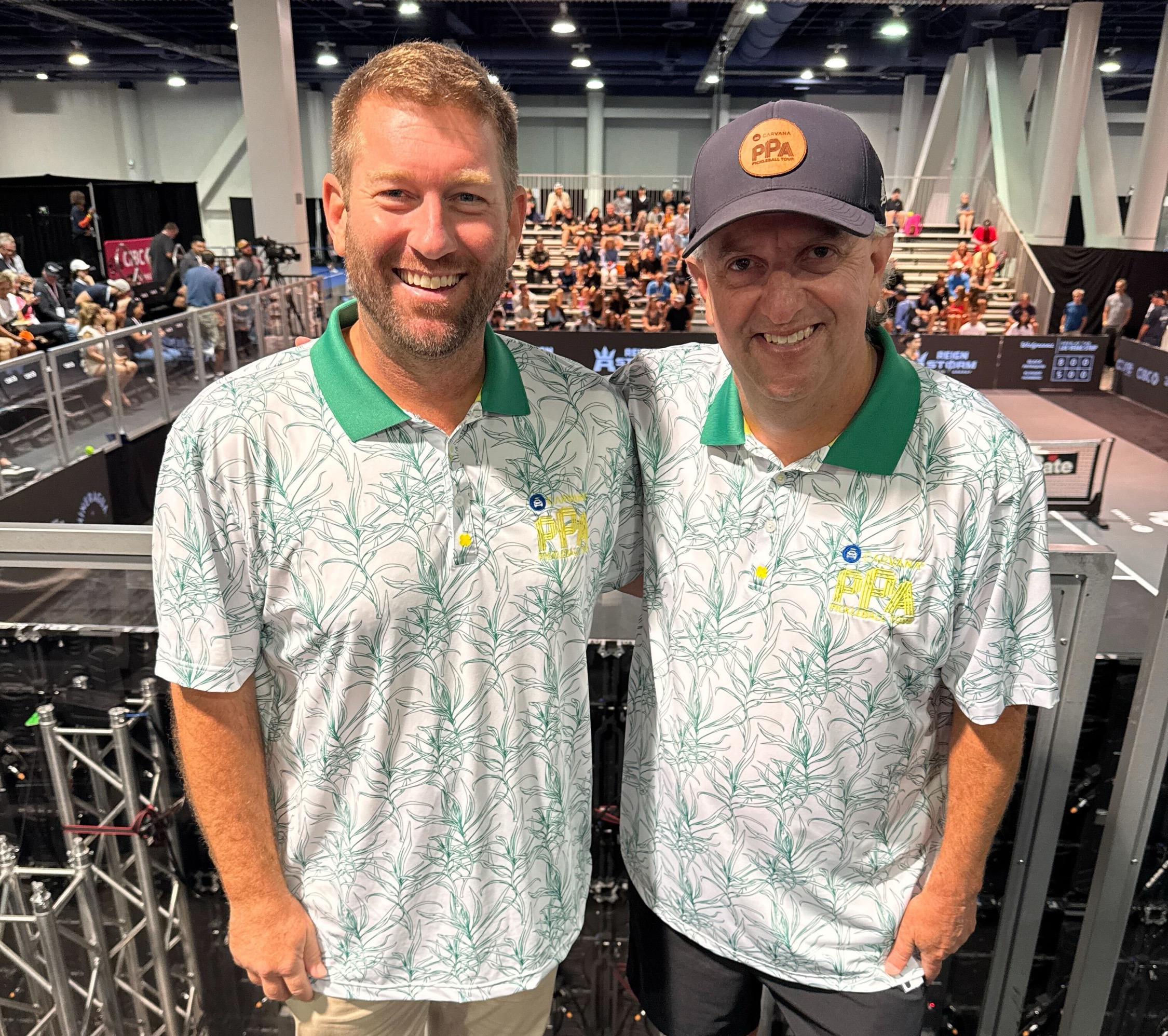 Stone and Fleming in matching white and green floral polo shirts