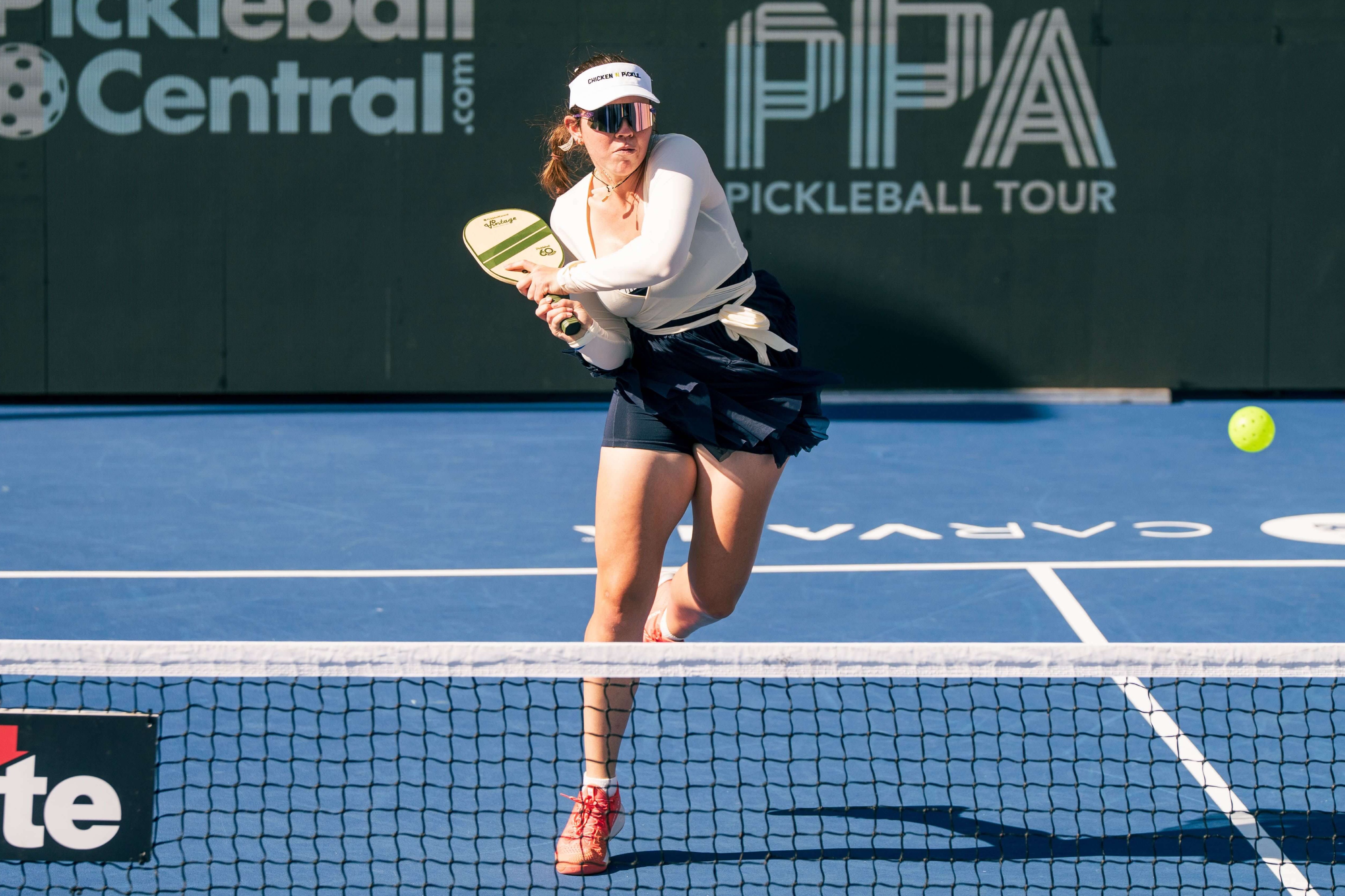 Johnson in a white wrap top adn twirly blue skirt