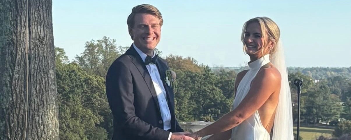 Kate Fahey and her new husband, Charlie holding hands on their wedding day