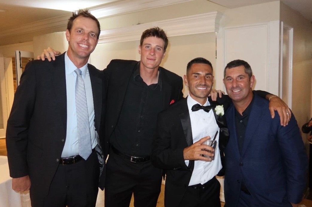 Sam Querrey, Roscoe Bellamy, Gabe Joseph, and Ryan Sheery in suits celebrating Joseph