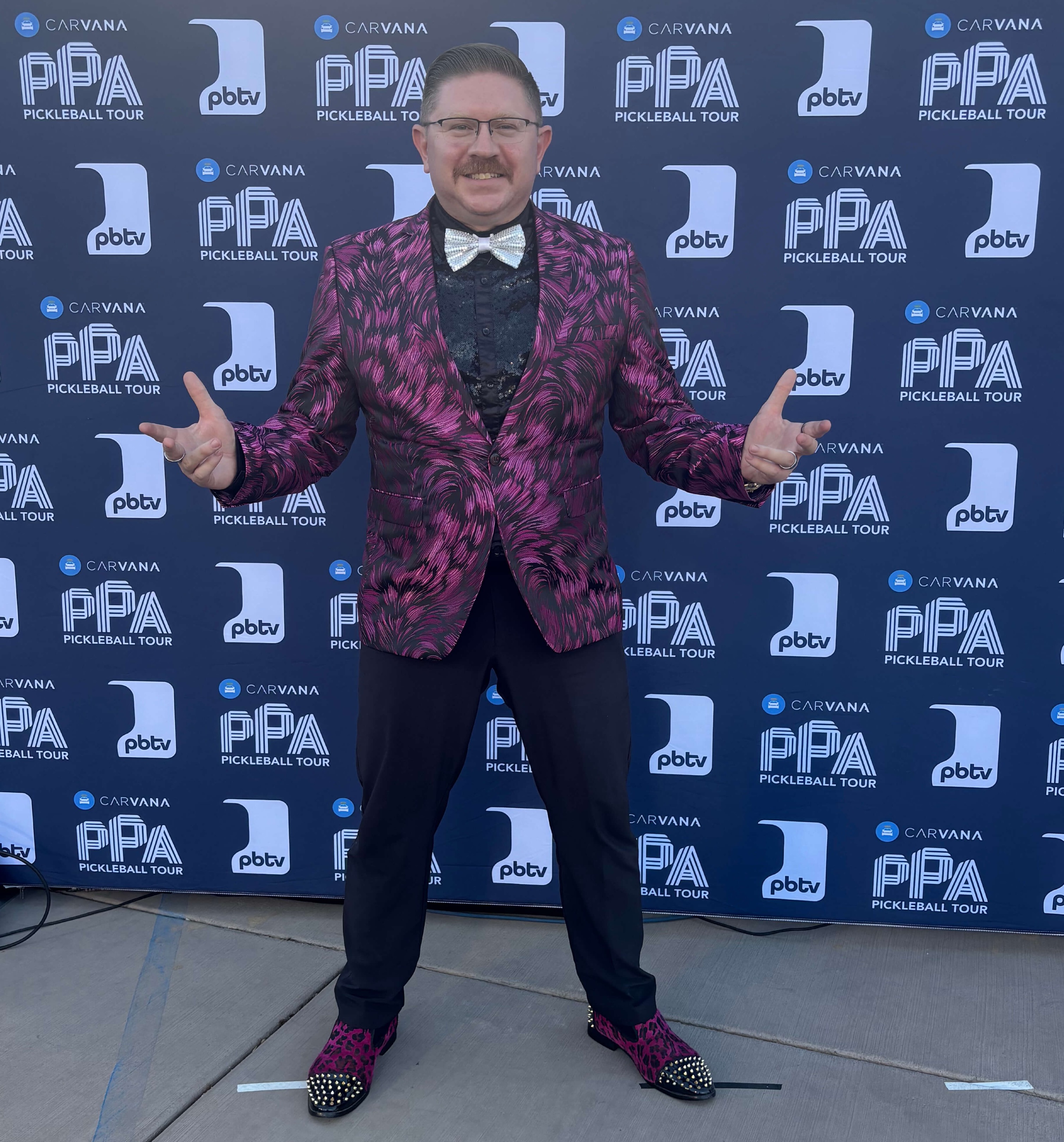The Young Professor in a purple suit with sudded shoes and a sparkly bow tie