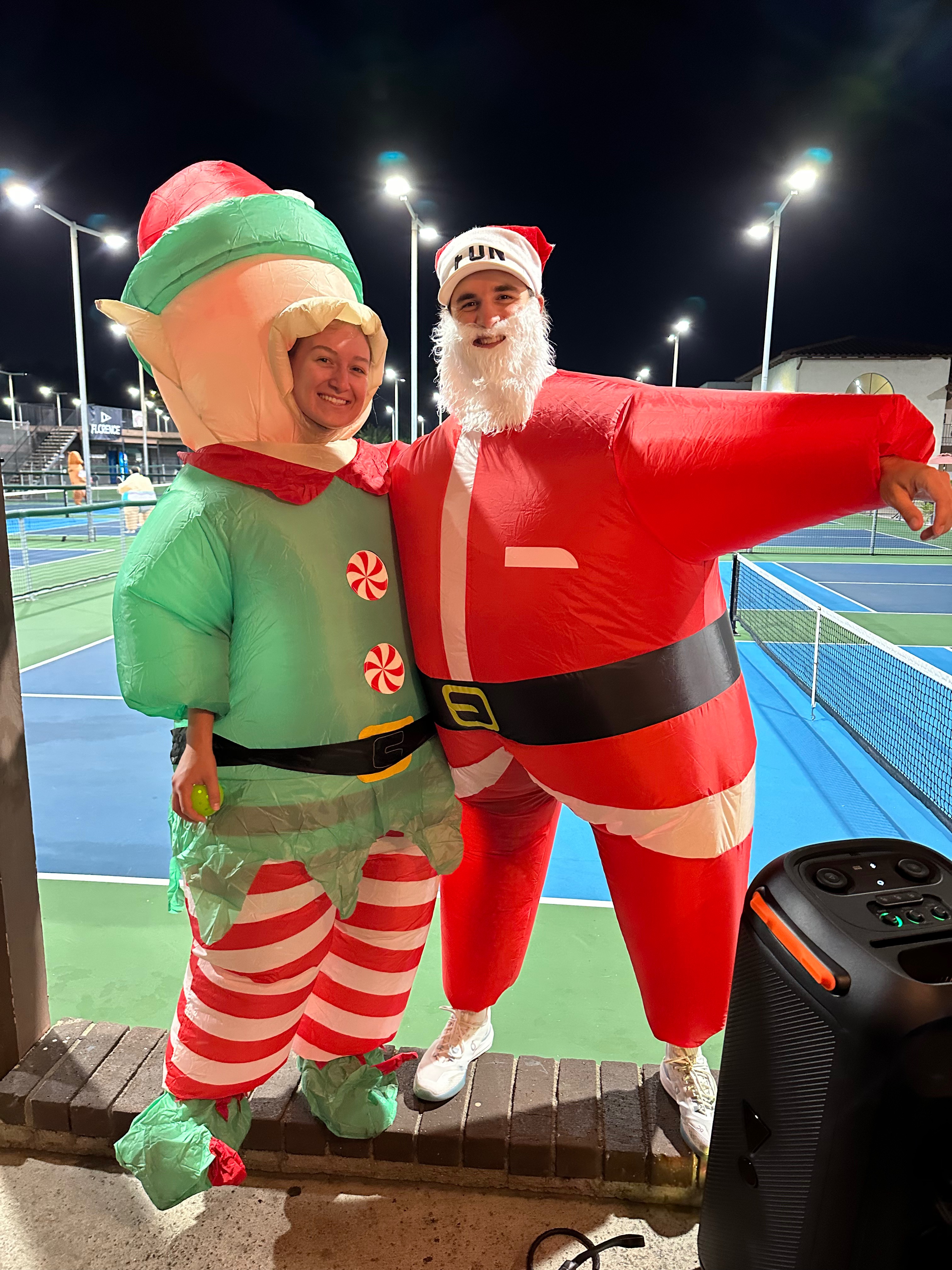 Brascia in an inflatable elf costume and Black in a Santa costume