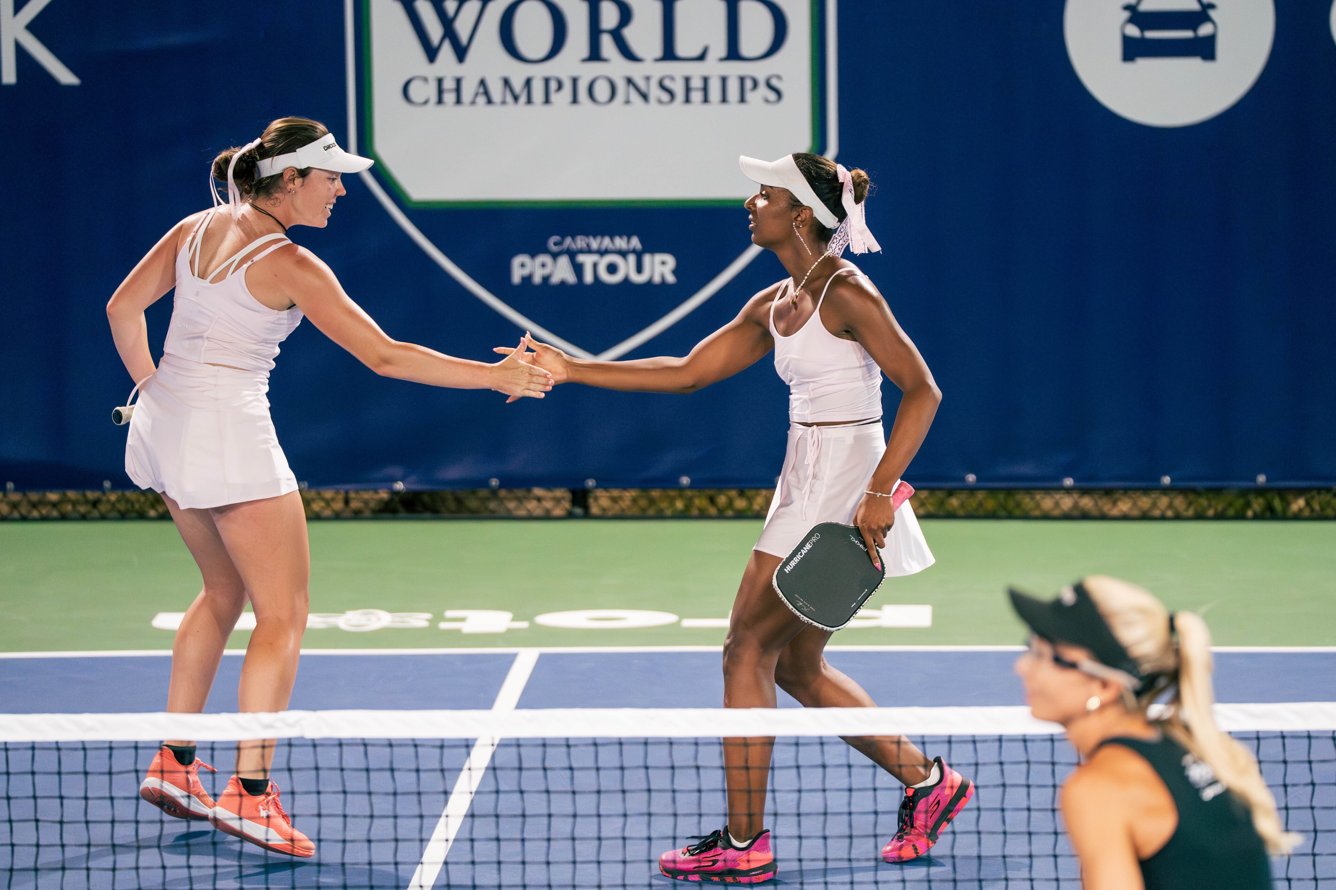 Johnson and Black in matching light pink wrap skirts and tops