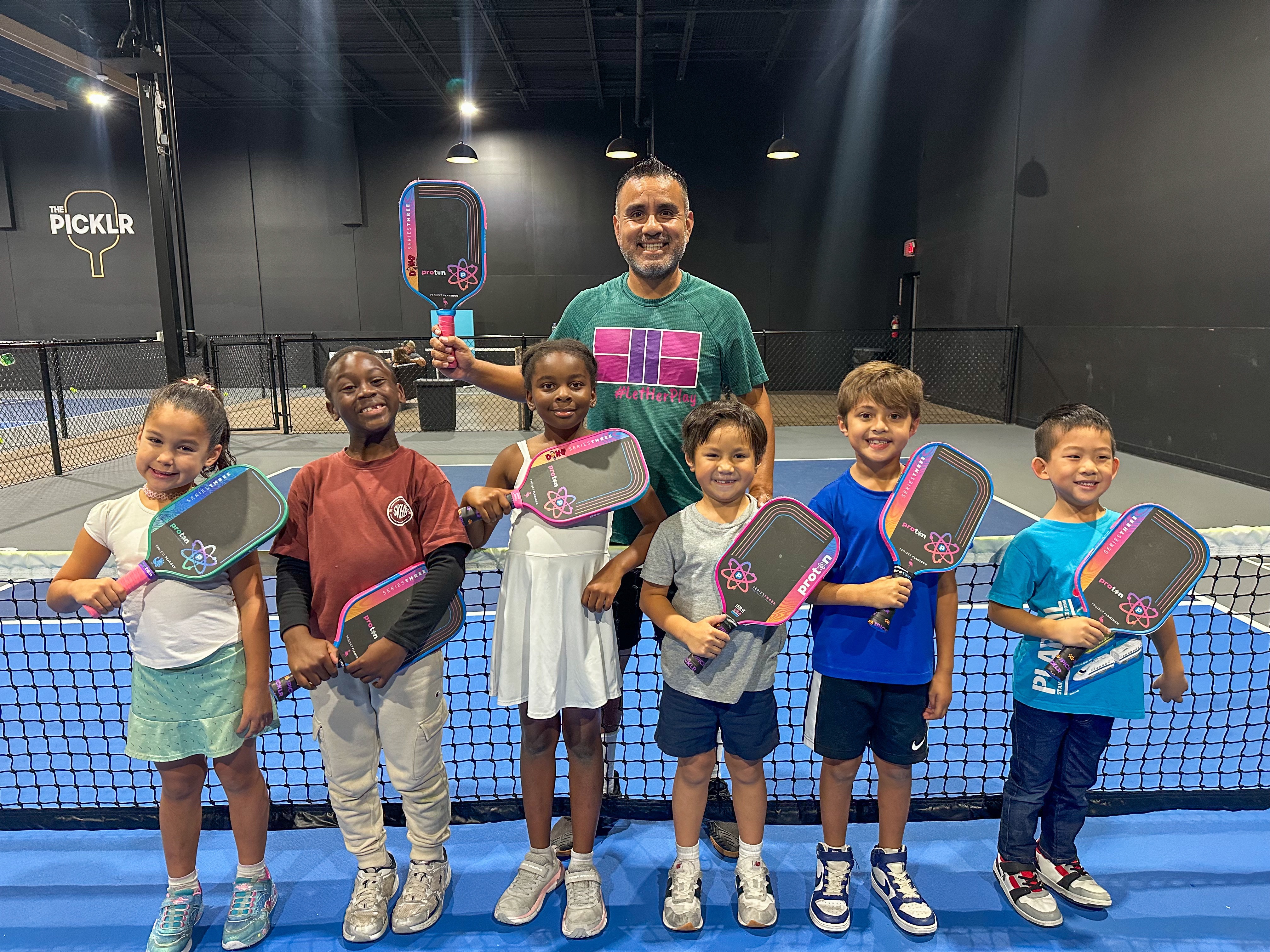Micah enjoying a pickleball lesson with Coach Dino Lopez.