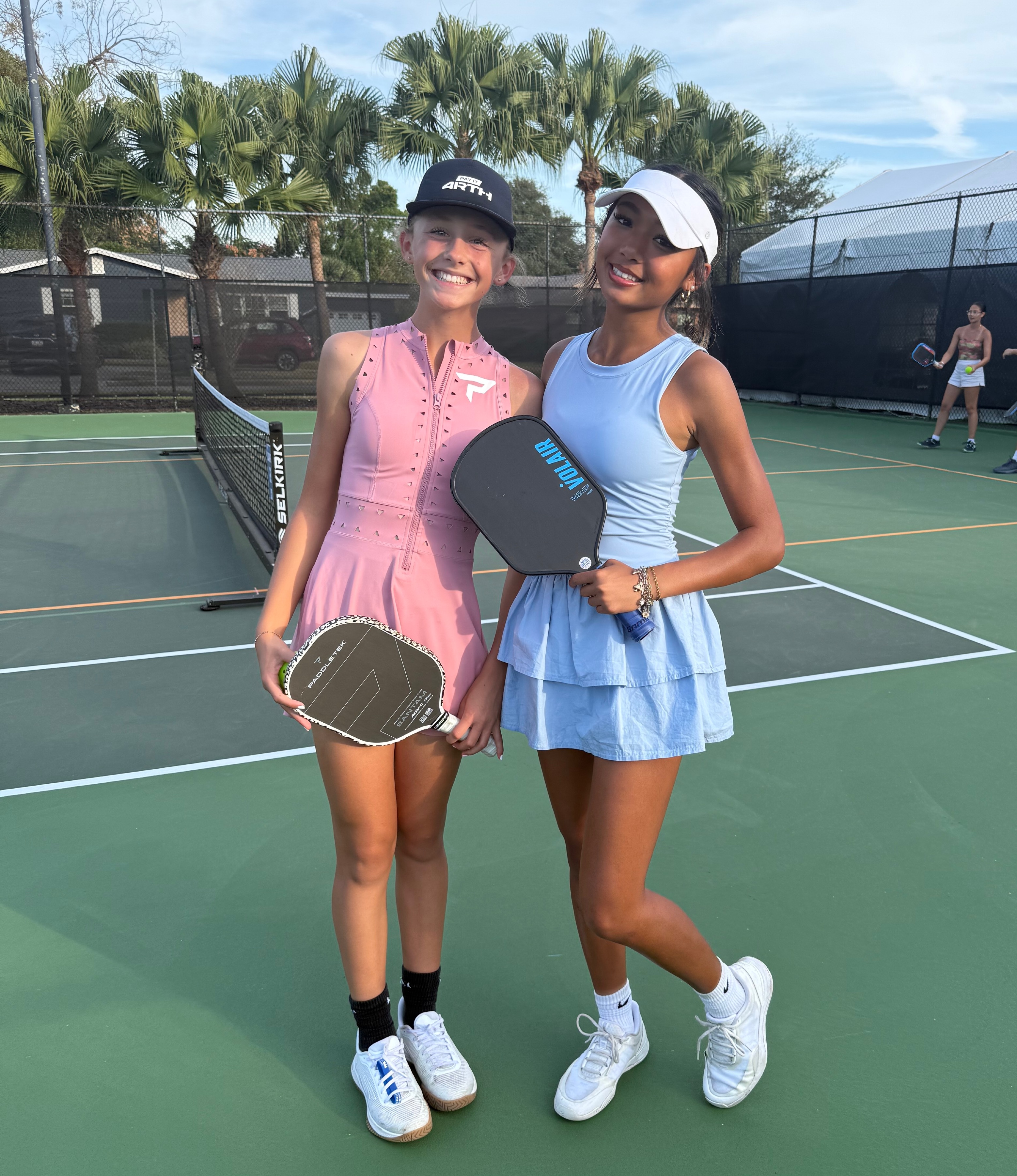 Hendershot in a pink dress and Yeh in a baby blue dress