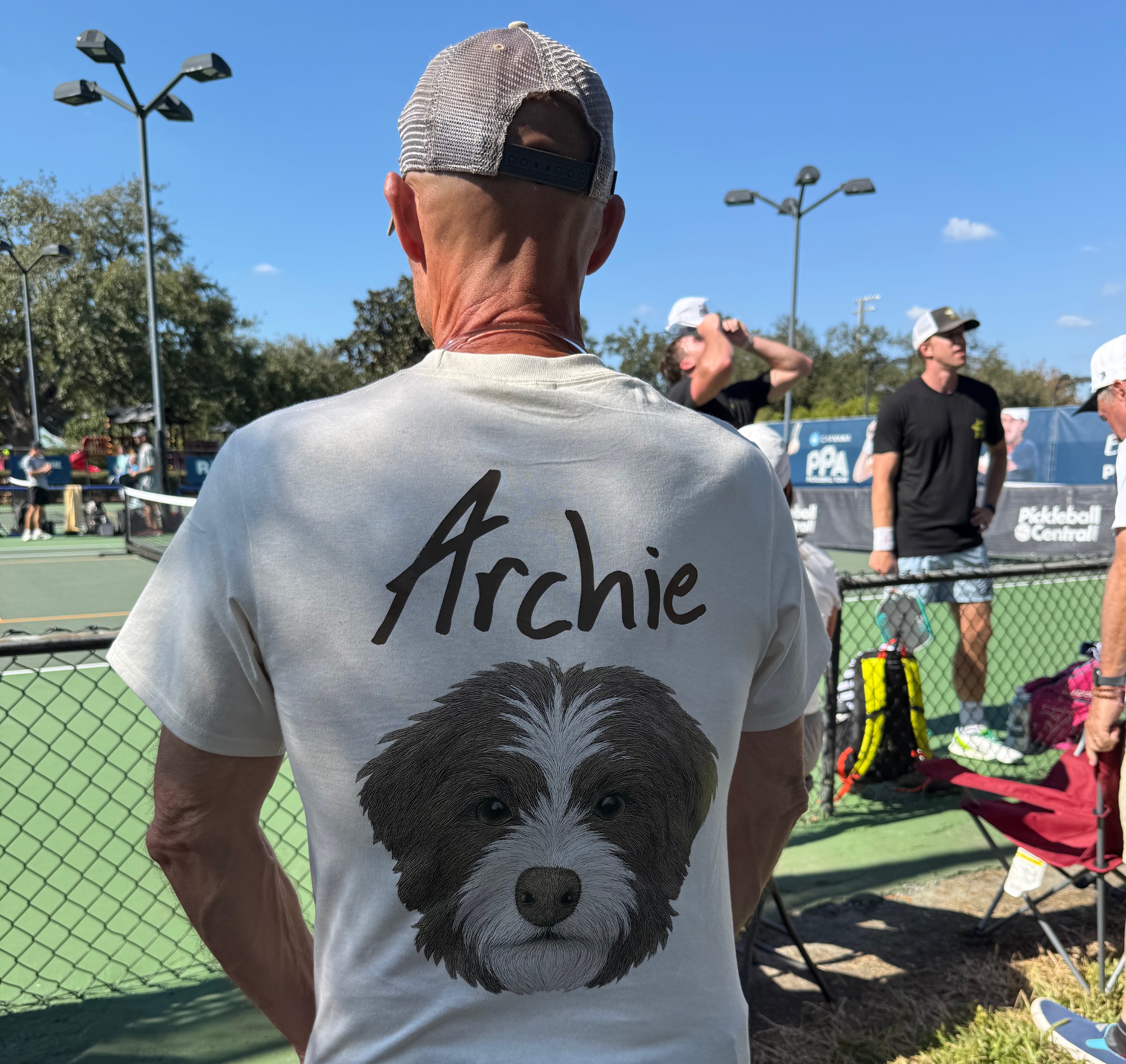 man wearing a graphic t-shirt with Archer's face on it
