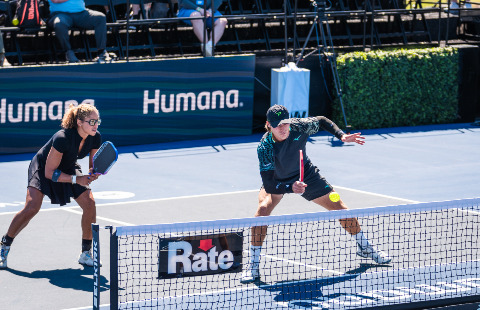 Jessie Irvine and Christian Alshon playing pickleball mixed doubles.