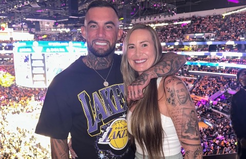 Tyrson McGuffin with his arm around his wife at a Los Angeles Lakers game.