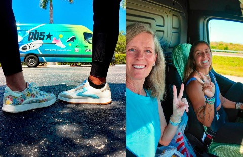 Alex and Marisa holding up a peace sign and smiling in front of the PB5star van